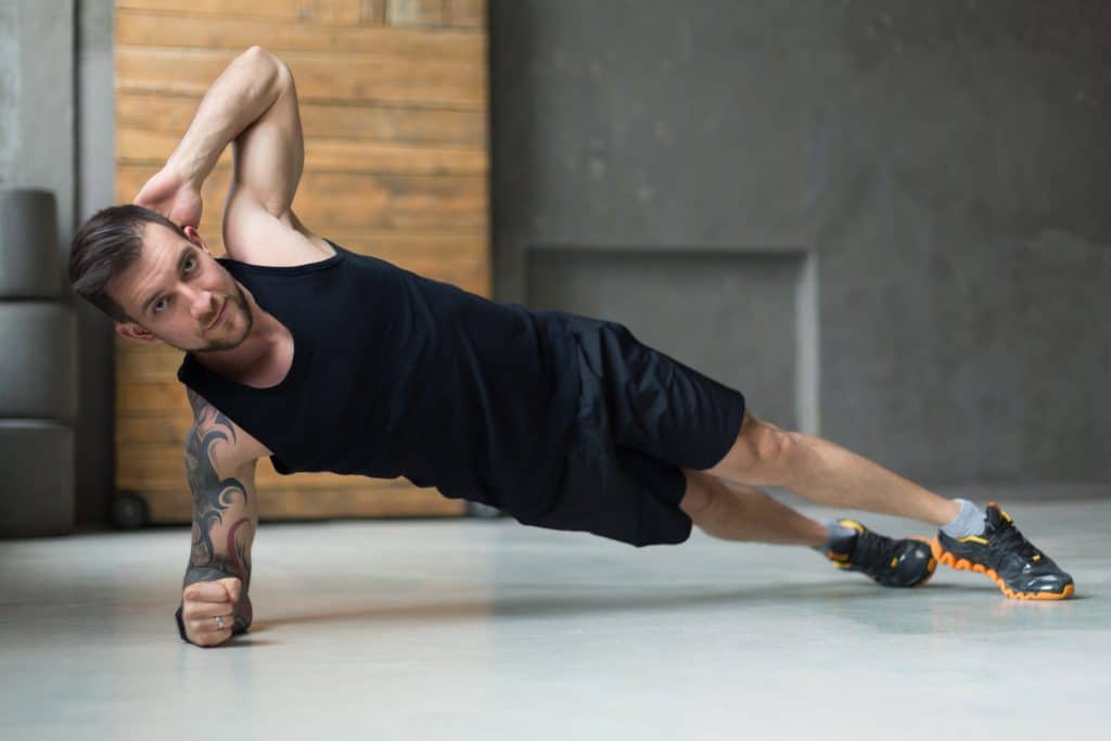 A man doing side plank exercise